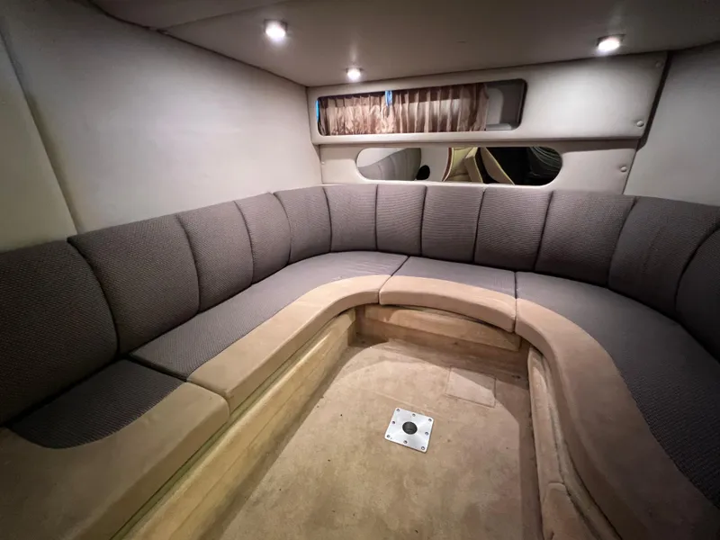 Slide: The Image of 2005 Chaparral Signature 350 interior with curved seating and soft lighting. - 36