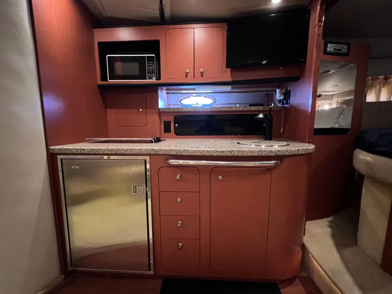 Slide: The Image of 2005 Chaparral Signature 350 yacht interior kitchen with microwave, fridge, and TV. - 41