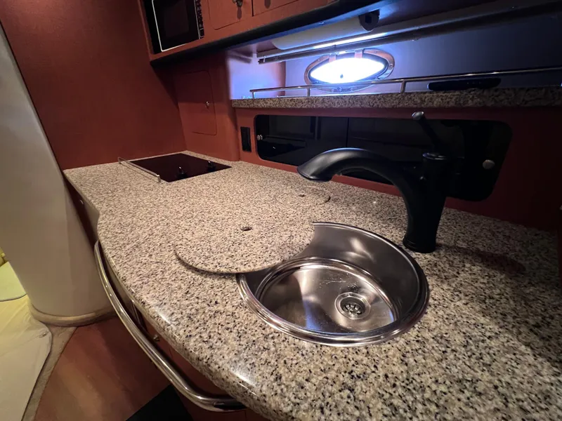 Slide: The Image of 2005 Chaparral Signature 350 yacht kitchen with granite countertop and stainless steel sink. - 43