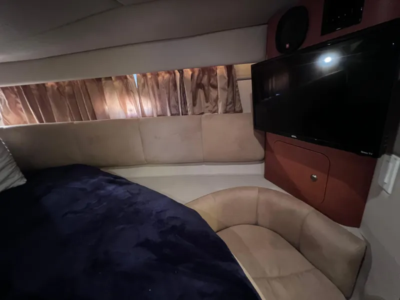 Slide: The Image of Interior of 2005 Chaparral Signature 350 yacht with TV, seating, and curtains. - 45