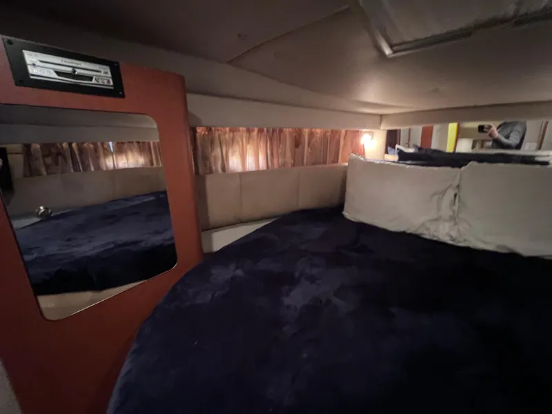 Slide: The Image of Interior cabin of 2005 Chaparral Signature 350 with cozy bedding and mirror. - 46