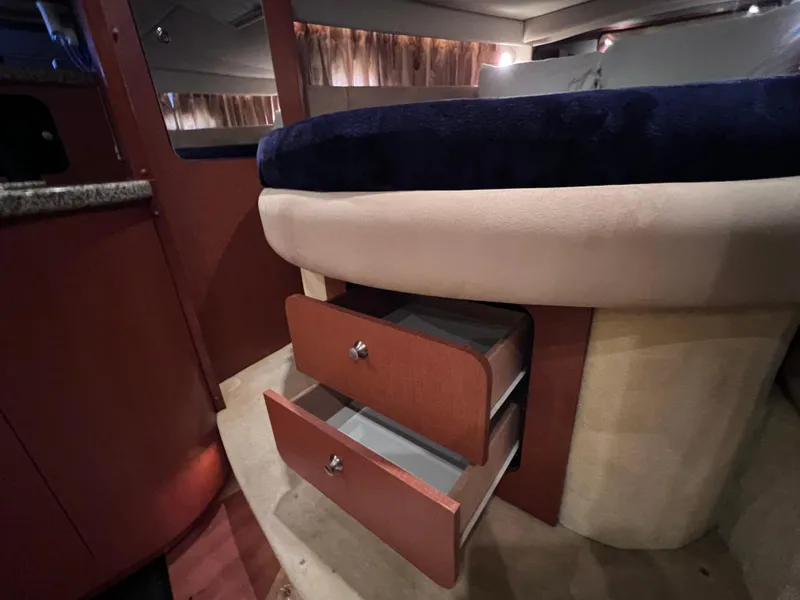 Slide: The Image of 2005 Chaparral Signature 350 cabin interior with open wooden storage drawers. - 47