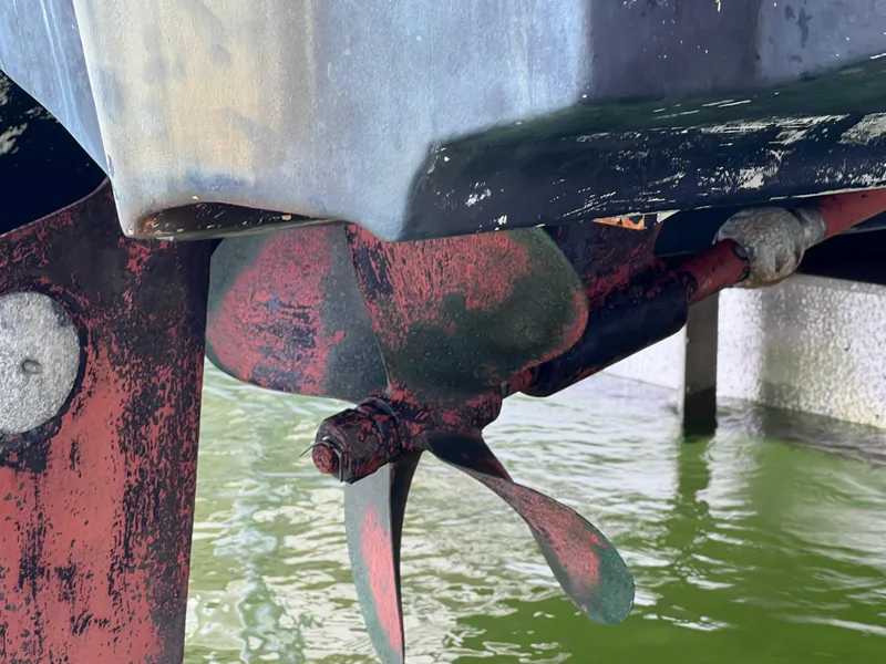 Slide: The Image of 2005 Chaparral Signature 350 boat propeller with visible wear, partially submerged in water. - 9
