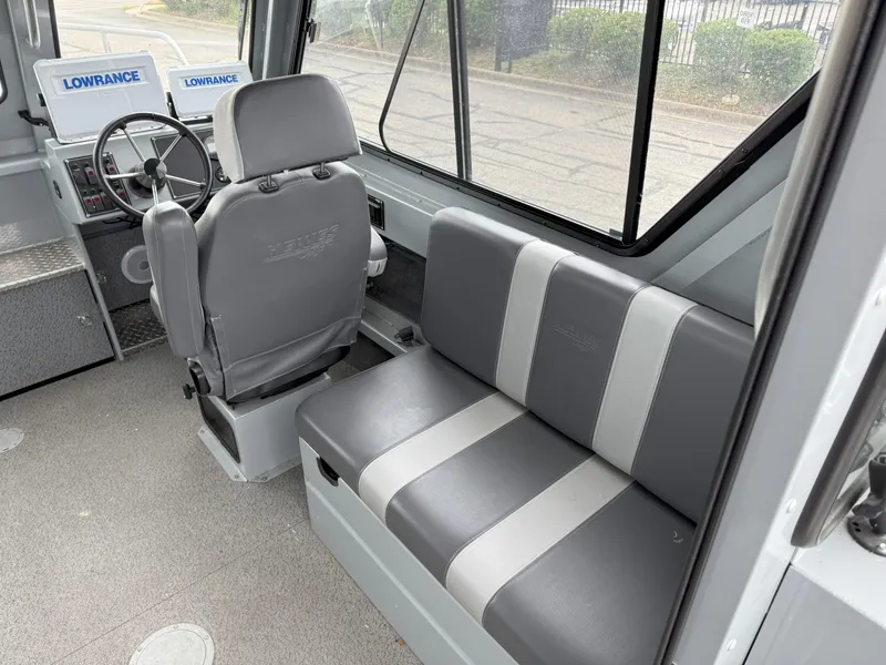 Slide: The Image of 2023 Hewescraft 240 Ocean Pro ET HT interior with seating and navigation equipment. - 10
