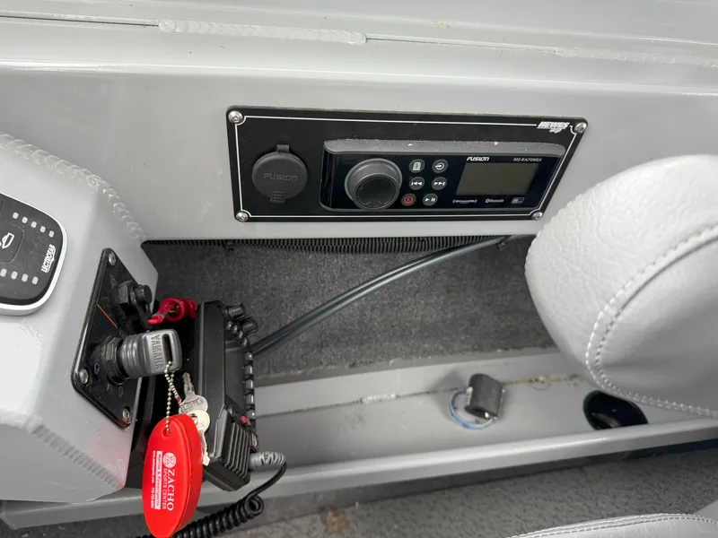 Slide: The Image of 2023 Hewescraft 240 Ocean Pro ET HT dashboard with Fusion stereo system and ignition key. - 12