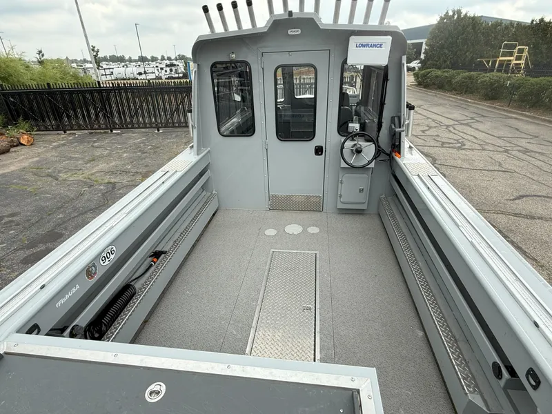 Slide: The Image of 2023 Hewescraft 240 Ocean Pro ET HT boat interior with steering wheel and rod holders. - 6