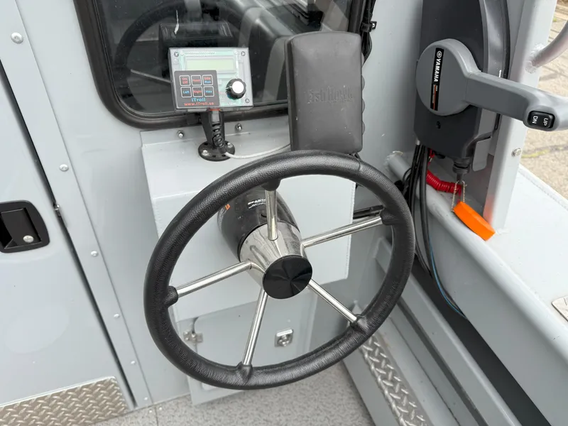 Slide: The Image of Steering wheel and controls of 2023 Hewescraft 240 Ocean Pro ET HT boat. - 8