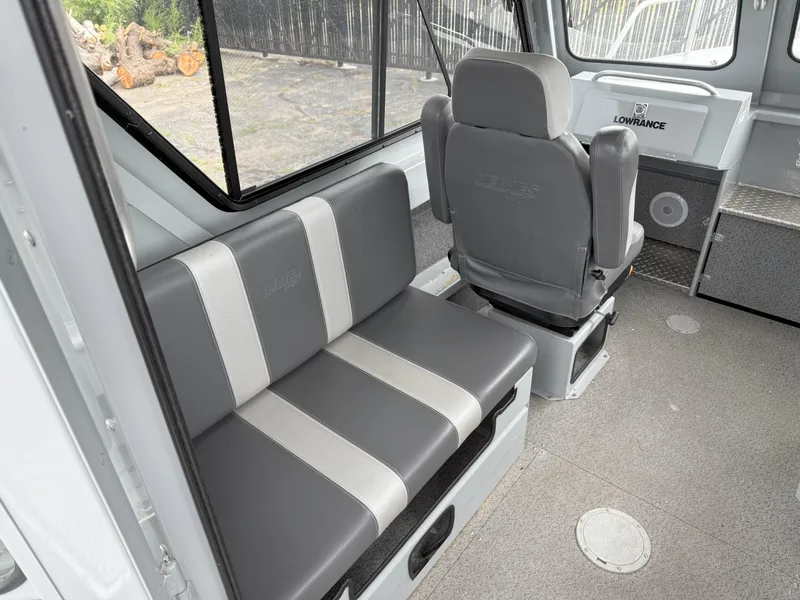 Slide: The Image of 2023 Hewescraft 240 Ocean Pro ET HT interior with gray seating and navigation equipment. - 9