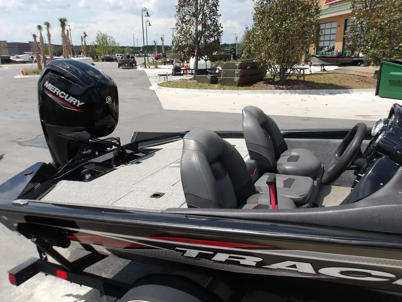 Slide: The Image of 2021 Tracker Pro Team 175 TXW boat with Mercury engine, parked outdoors. - 2