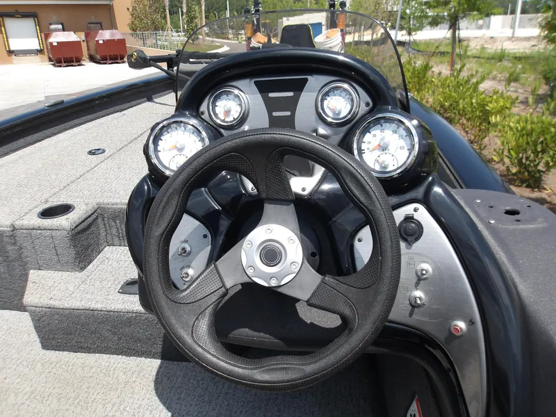 Slide: The Image of 2021 Tracker Pro Team 175 TXW boat dashboard with steering wheel and gauges. - 5