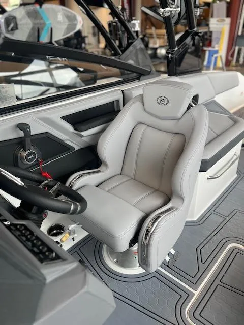 Slide: The Image of 2025 Cobalt R6 Surf boat interior with sleek captain's chair and modern dashboard. - 12
