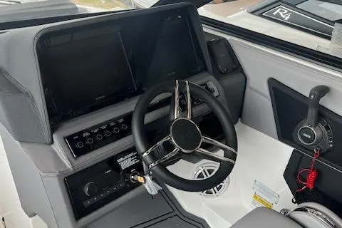 Slide: The Image of 2025 Cobalt R6 Surf boat dashboard with steering wheel and control panel. - 14