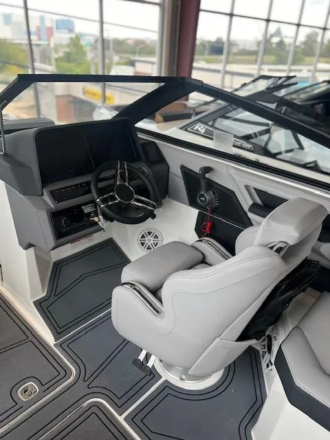 Slide: The Image of 2025 Cobalt R6 Surf boat interior with modern helm and sleek seating design. - 16