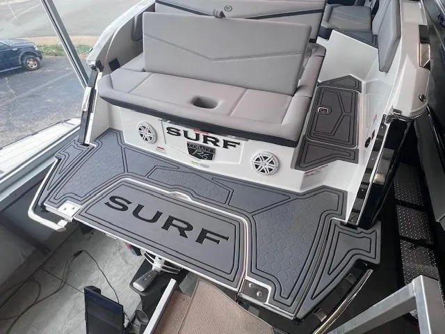 Slide: The Image of 2025 Cobalt R6 Surf boat with gray seating and "SURF" branded deck. - 27