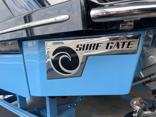 Slide: The Image of 2025 Cobalt R6 Surf boat with Surf Gate feature, blue and black design. - 28