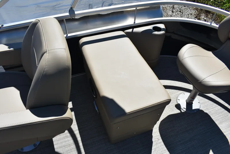 Slide: The Image of 2024 SunChaser Vista 20 Fish boat interior with beige seating and storage. - 6