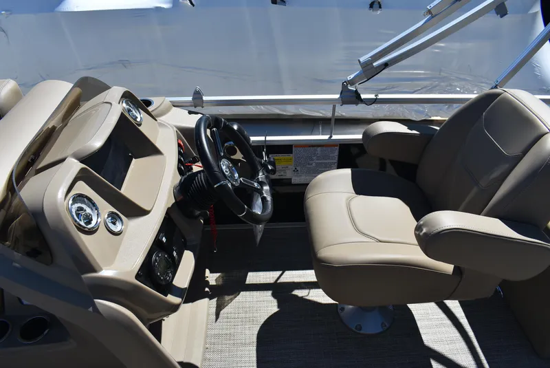 Slide: The Image of 2024 SunChaser Vista 20 Fish boat interior with steering wheel and captain's chair. - 8