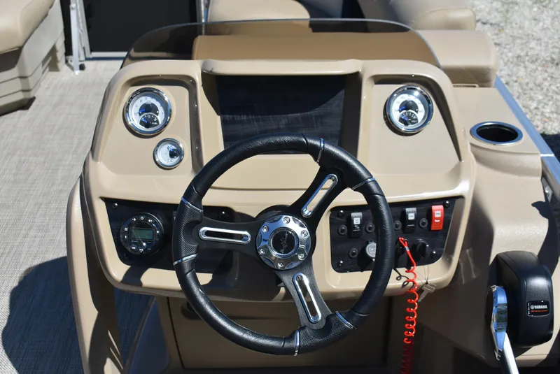 Slide: The Image of 2024 SunChaser Vista 20 Fish boat dashboard with steering wheel and control panel. - 9