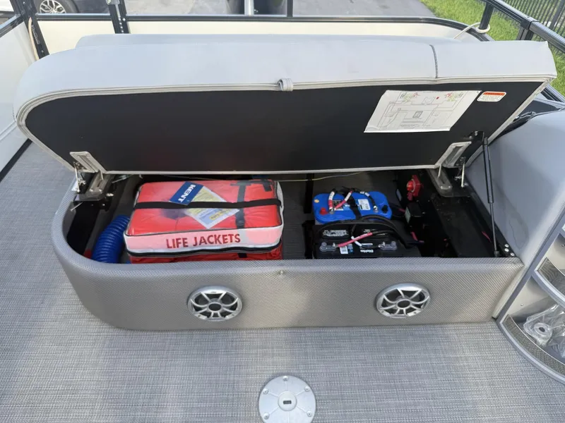 Slide: The Image of Storage compartment of 2024 Regency 250 DL3 boat with life jackets and battery. - 23