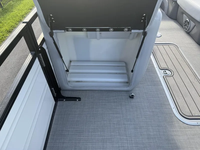 Slide: The Image of 2024 Regency 250 DL3 boat interior storage compartment with gray flooring. - 25