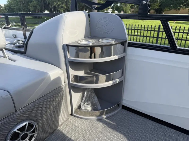 Slide: The Image of 2024 Regency 250 DL3 boat interior with cup holders and storage shelves. - 26