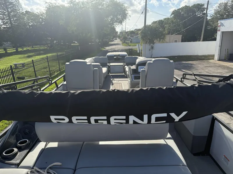 Slide: The Image of 2024 Regency 250 DL3 pontoon boat with spacious seating and sleek design. - 29