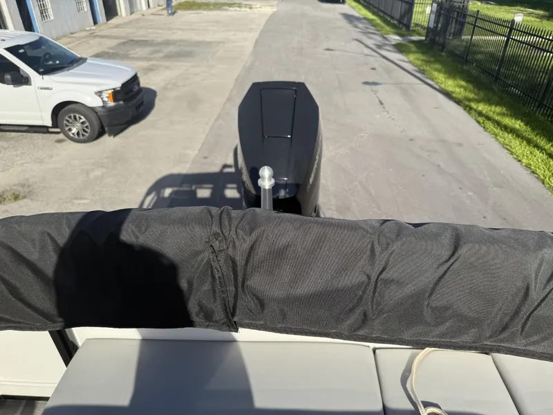 Slide: The Image of 2024 Regency 250 DL3 boat on trailer, parked near a white truck. - 31