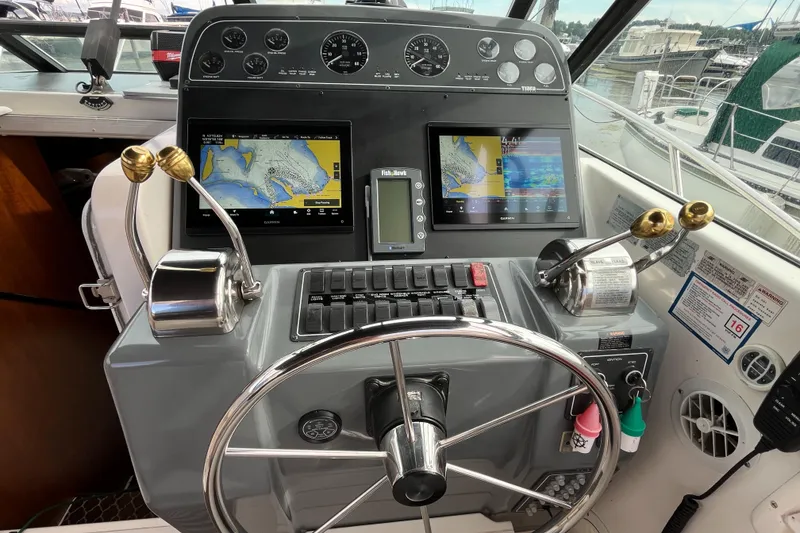 Slide: The Image of Cockpit of 2000 Tiara Yachts 3100 Open with navigation screens and controls. - 10