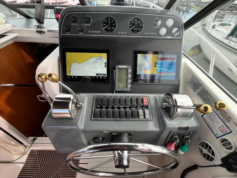 Slide: The Image of Control panel of a 2000 Tiara Yachts 3100 Open with navigation screens and gauges. - 11