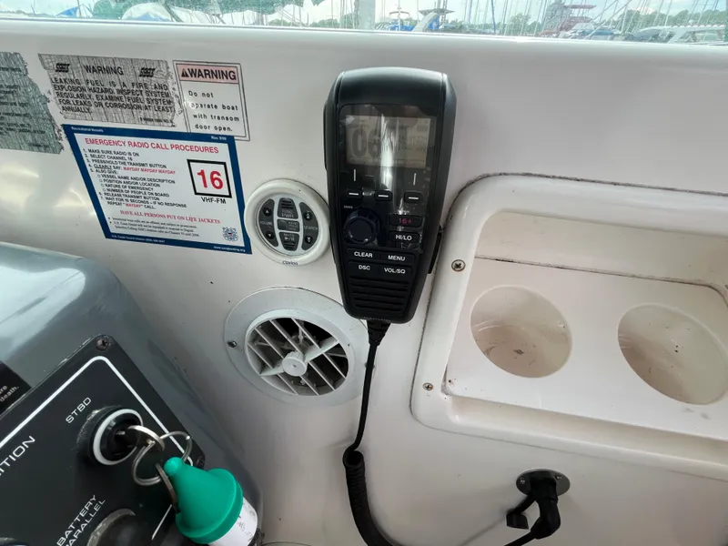 Slide: The Image of Control panel of a 2000 Tiara Yachts 3100 Open with radio and warning labels. - 12