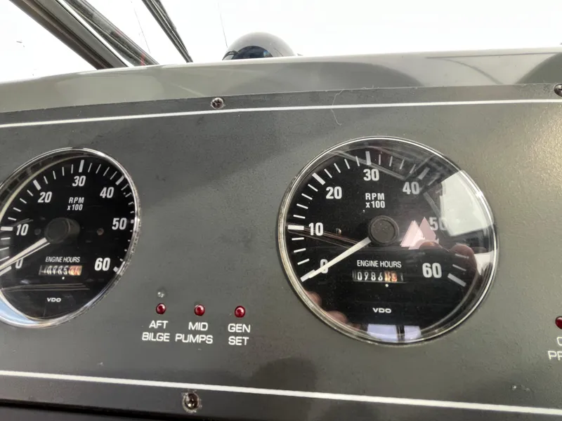 Slide: The Image of Dashboard of a 2000 Tiara Yachts 3100 Open showing RPM gauges and engine hours. - 14