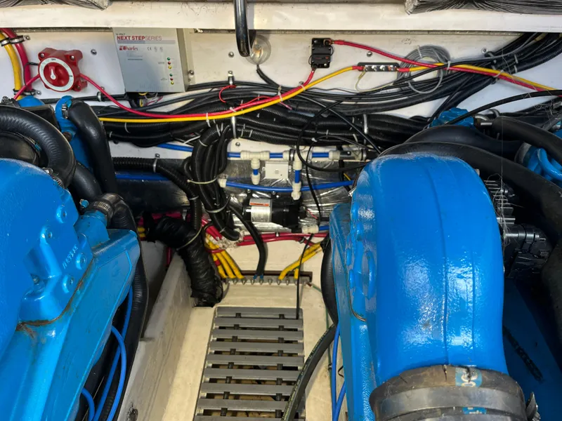Slide: The Image of Engine compartment of a 2000 Tiara Yachts 3100 Open, featuring blue engine components and wiring. - 19