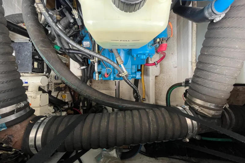 Slide: The Image of Engine compartment of a 2000 Tiara Yachts 3100 Open, showcasing hoses and mechanical components. - 20