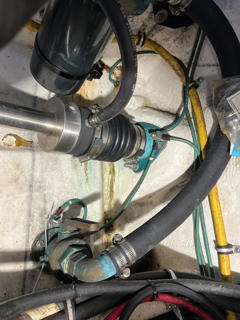 Slide: The Image of Engine compartment of a 2000 Tiara Yachts 3100 Open, showing hoses and mechanical components. - 22