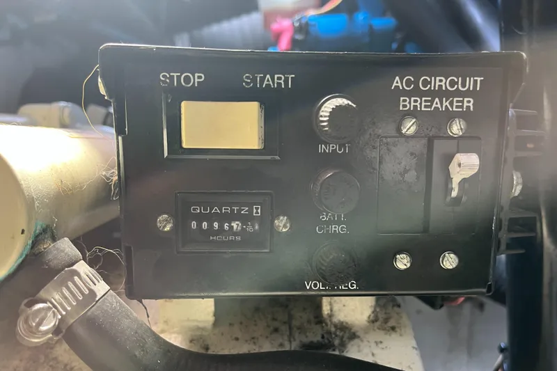 Slide: The Image of Control panel of a 2000 Tiara Yachts 3100 Open, featuring start/stop and AC circuit breaker. - 24