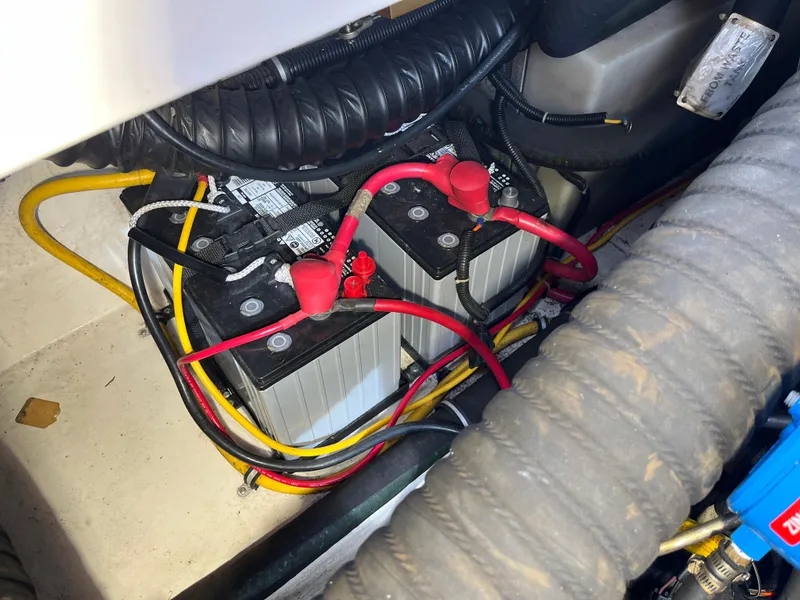 Slide: The Image of Battery compartment of a 2000 Tiara Yachts 3100 Open, featuring cables and connections. - 25