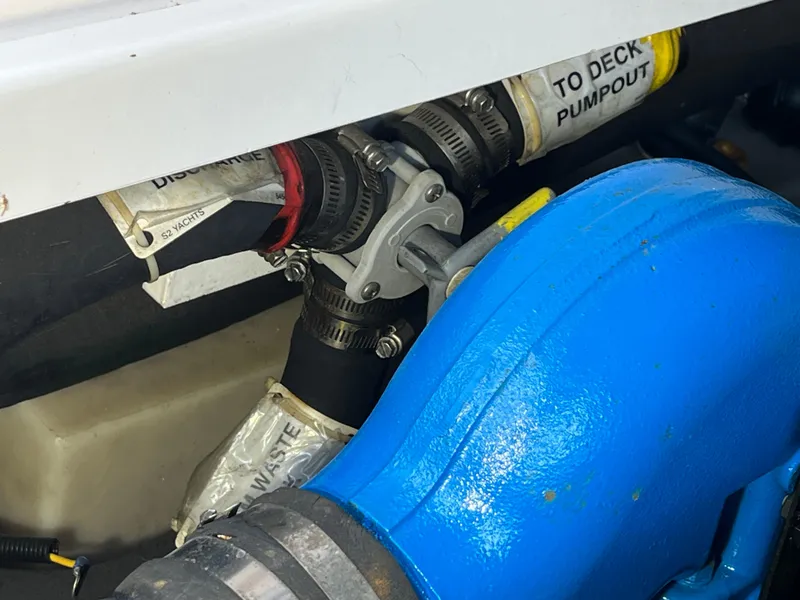 Slide: The Image of Engine compartment of a 2000 Tiara Yachts 3100 Open, showing hoses and pump connections. - 26