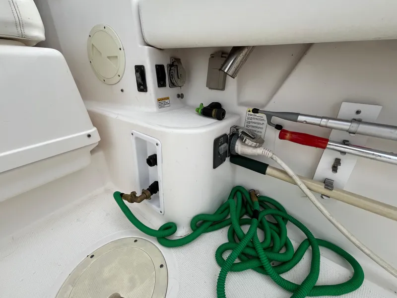 Slide: The Image of 2000 Tiara Yachts 3100 Open deck with hoses and utility connections. - 28