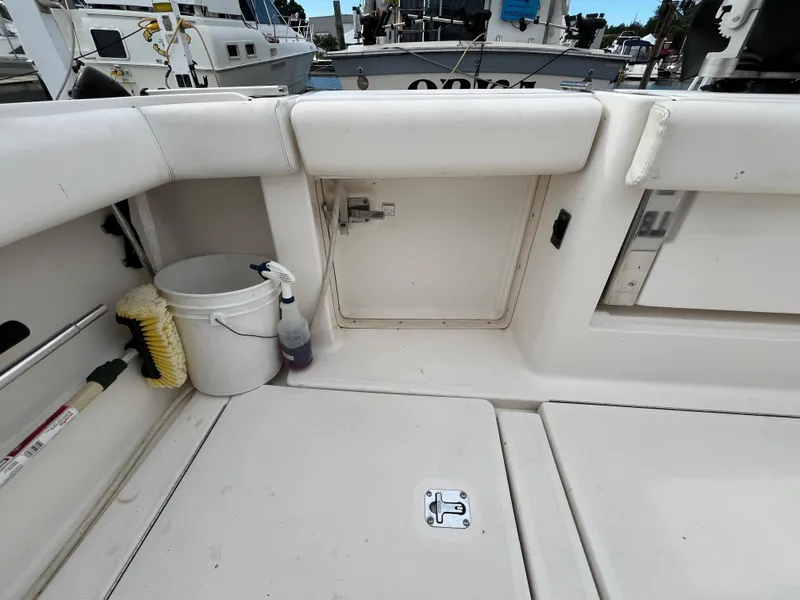 Slide: The Image of 2000 Tiara Yachts 3100 Open deck with cleaning supplies and storage compartments. - 29