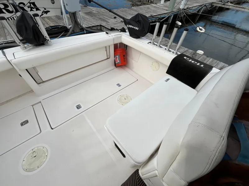 Slide: The Image of 2000 Tiara Yachts 3100 Open boat interior with seating and fishing rod holders. - 34
