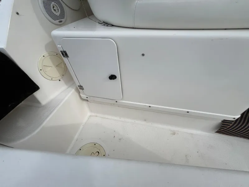 Slide: The Image of Interior view of a 2000 Tiara Yachts 3100 Open, featuring storage compartment and seating. - 40