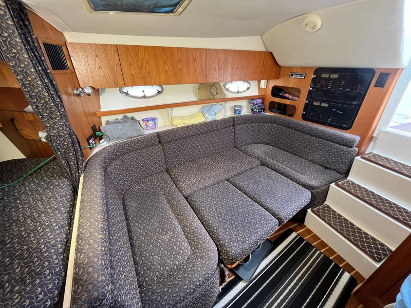 Slide: The Image of 2000 Tiara Yachts 3100 Open interior with cozy seating and wooden cabinetry. - 46