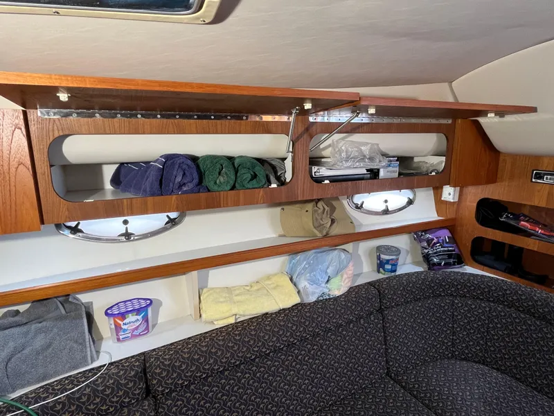 Slide: The Image of Interior of a 2000 Tiara Yachts 3100 Open with storage and seating area. - 47