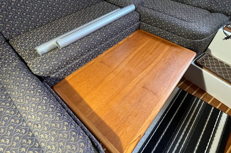 Slide: The Image of Interior of 2000 Tiara Yachts 3100 Open with wooden table and patterned seating. - 48