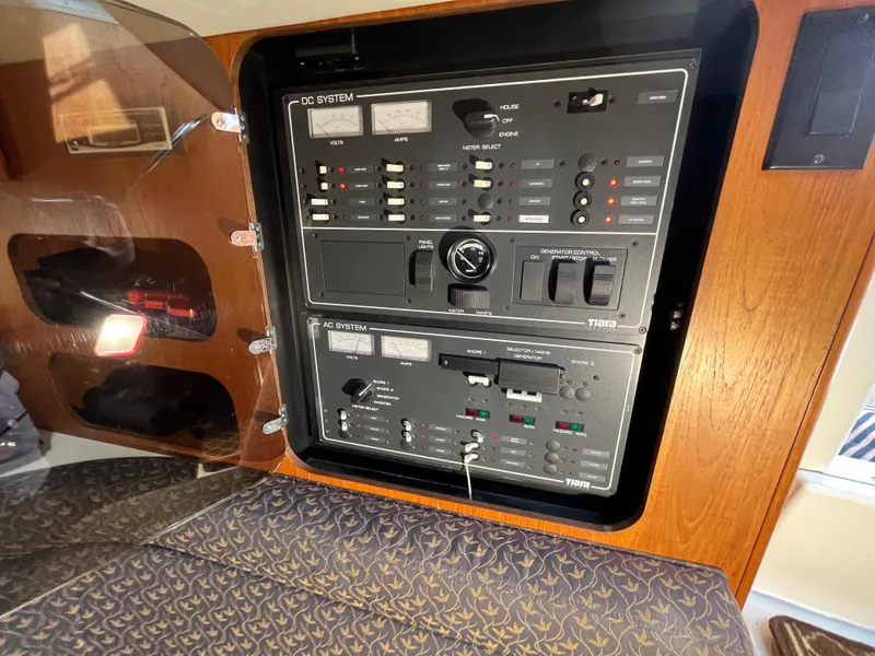Slide: The Image of Electrical control panel inside a 2000 Tiara Yachts 3100 Open boat cabin. - 49