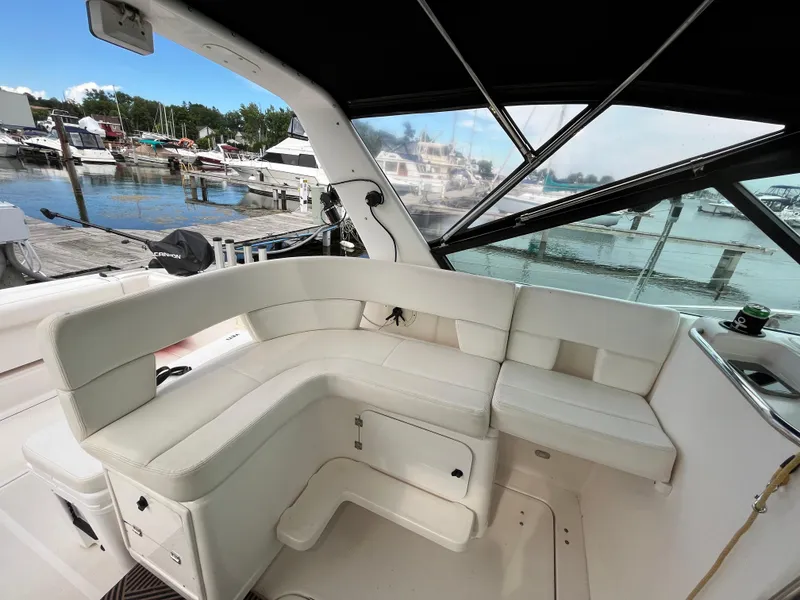 Slide: The Image of 2000 Tiara Yachts 3100 Open interior with white seating, docked at marina. - 6
