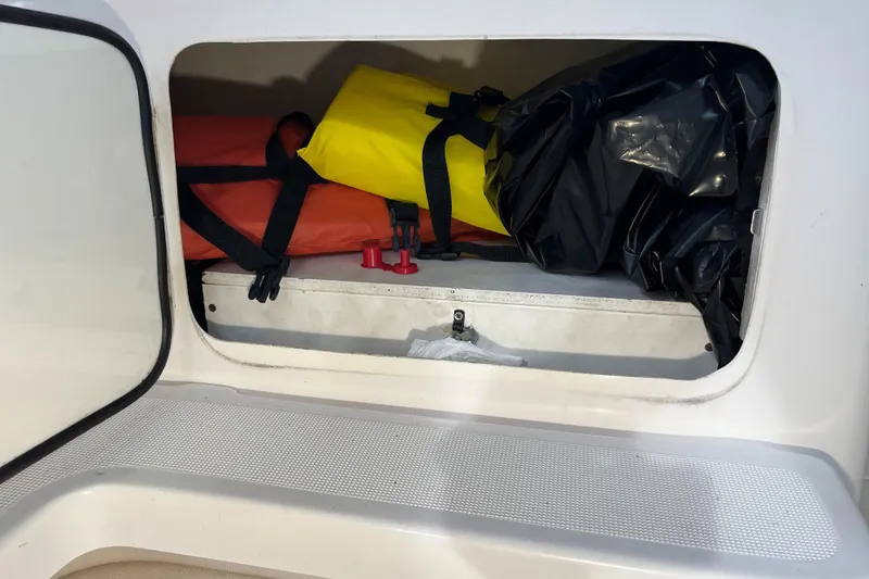 Slide: The Image of Storage compartment on a 2000 Tiara Yachts 3100 Open, containing life jackets and gear. - 7