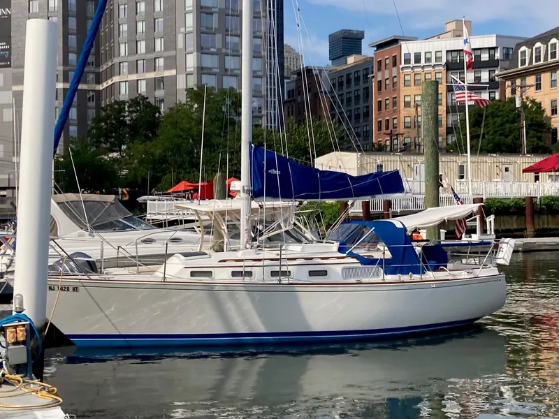 The Image of 1982 Sabre 30 sailboat docked in urban marina, surrounded by city buildings. - 0