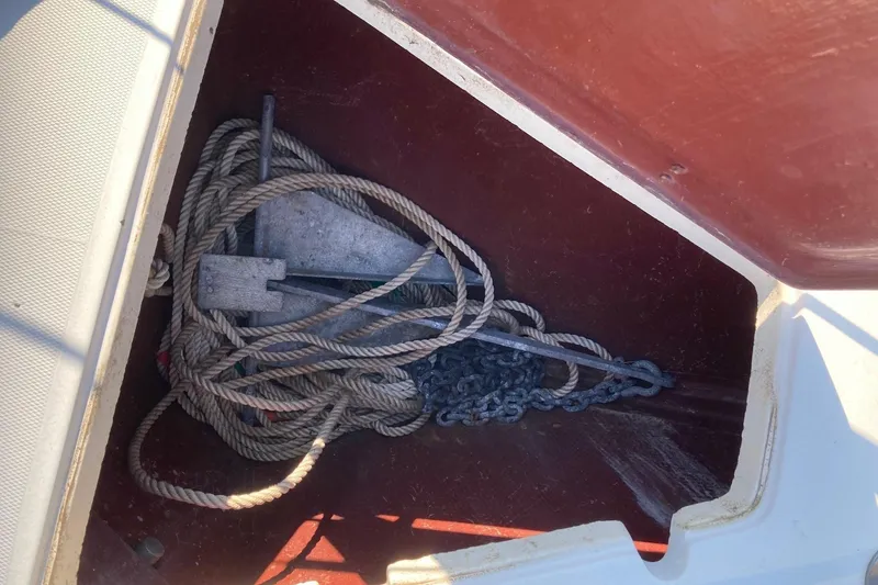 Slide: The Image of Anchor and rope stored in a 1982 Sabre 30 sailboat compartment. - 14