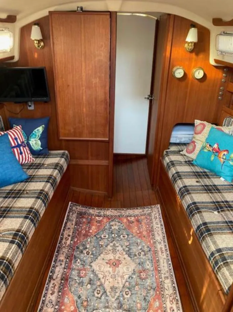 Slide: The Image of Interior of a 1982 Sabre 30 sailboat with cozy seating and nautical decor. - 17